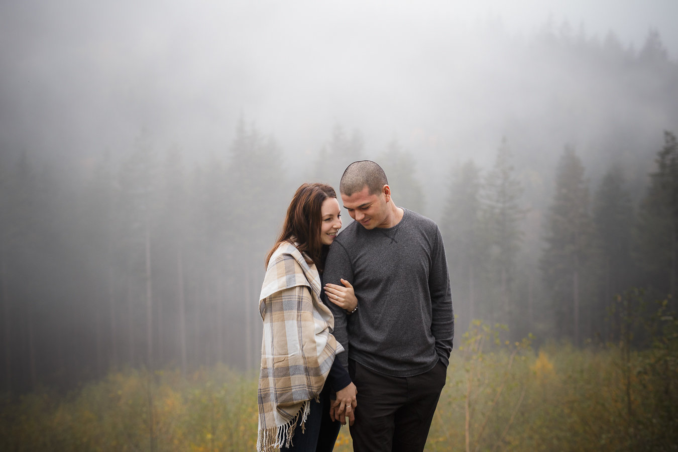 Young couple in a foggy forest in BC